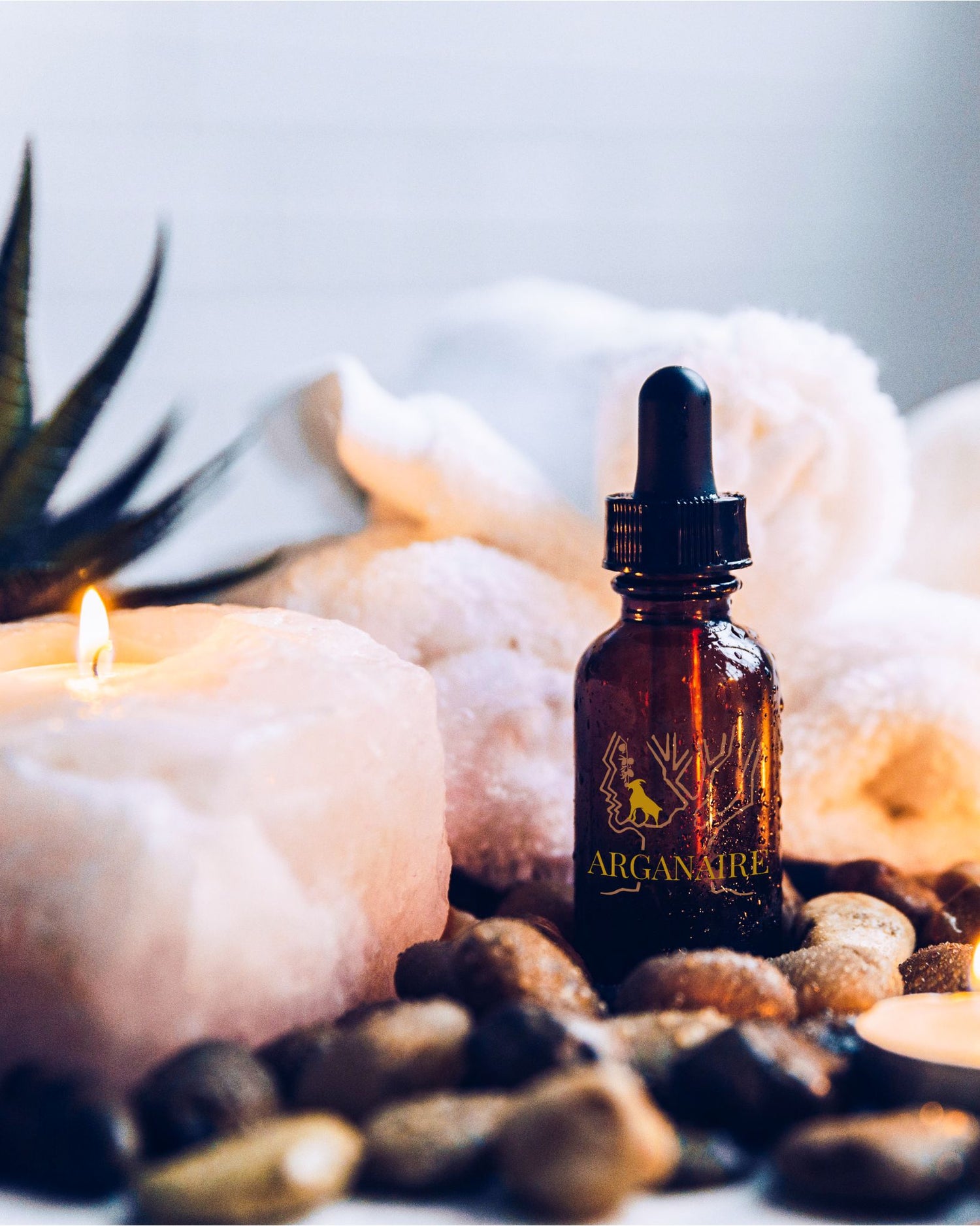 Arganaire Hair & Beard Oil bottle on candlelit vanity, luxury grooming ritual.